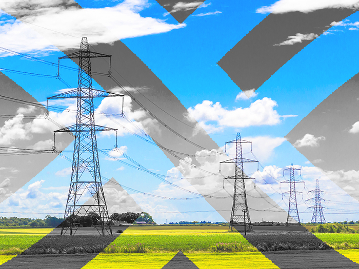 power pylons with green grass and blue sky